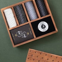 a set of playing cards in a wooden box