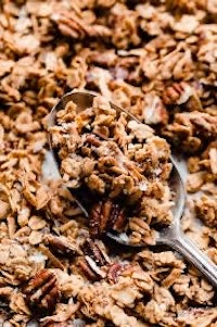 a spoonful of granola on a baking sheet