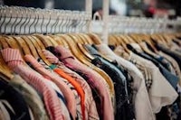 a rack of clothes on hangers in a clothing store